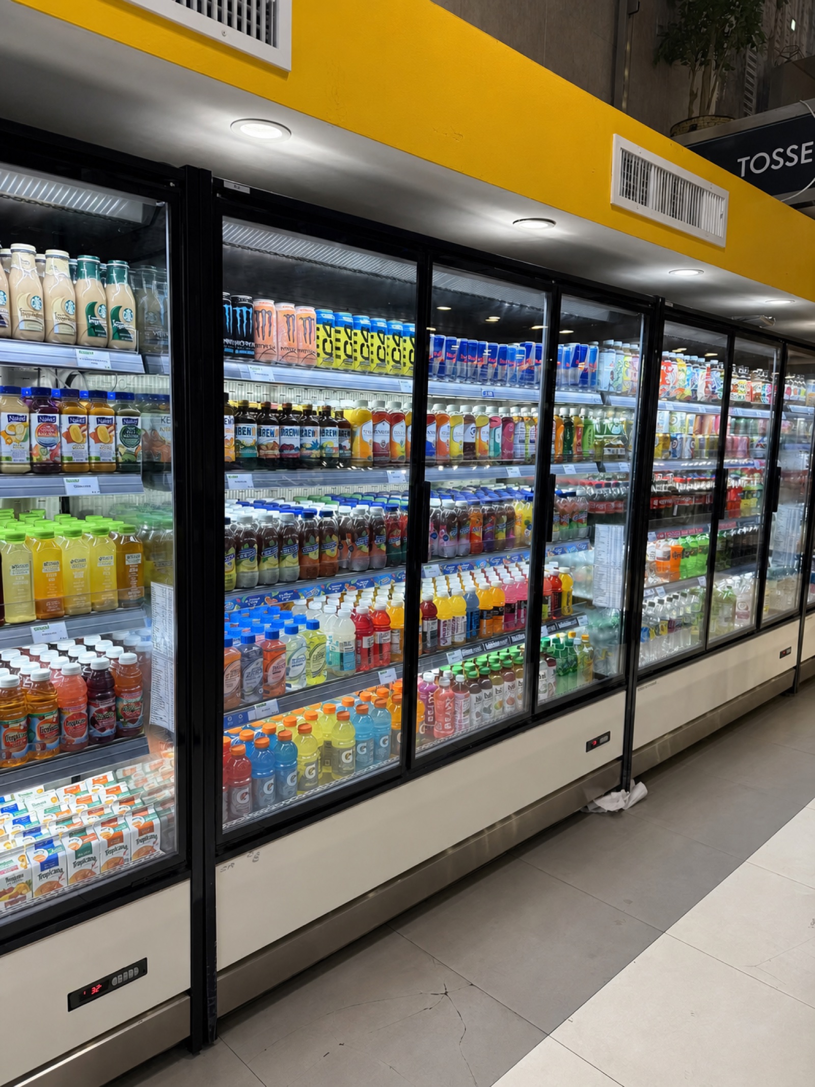 Beverages displayed inside a retail refrigerator